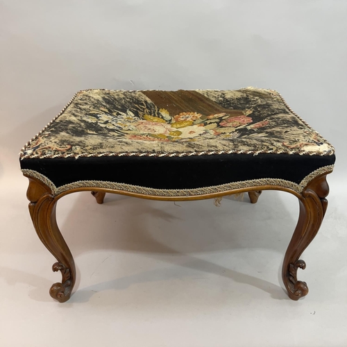 379 - A Victorian walnut stool, rectangular having the original floral needlework cover and on moulded cab... 