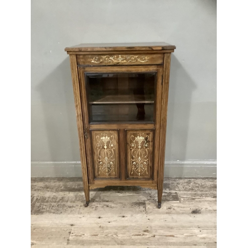 386 - A Victorian rosewood music cabinet inlaid with ivorine and boxwood having a half glazed and panelled... 