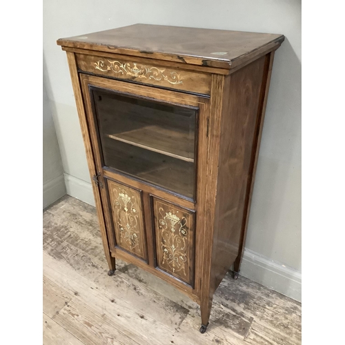 386 - A Victorian rosewood music cabinet inlaid with ivorine and boxwood having a half glazed and panelled... 