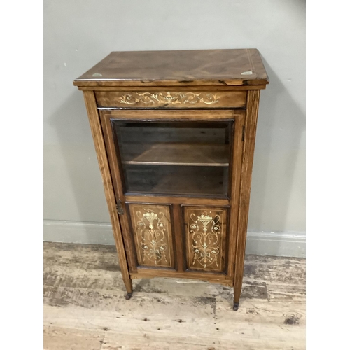 386 - A Victorian rosewood music cabinet inlaid with ivorine and boxwood having a half glazed and panelled... 