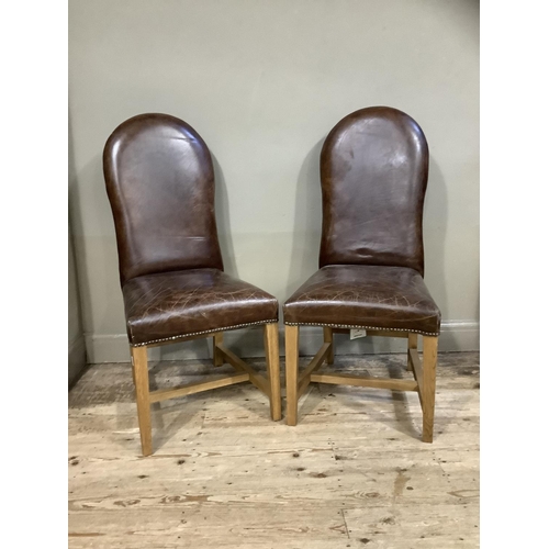 389 - A pair of brown leather close nail upholstered chairs on square framing