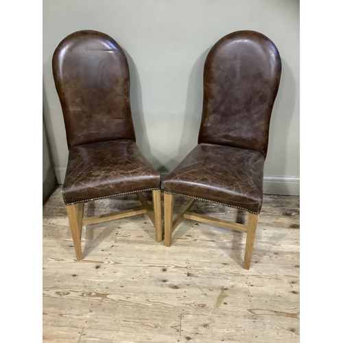 389 - A pair of brown leather close nail upholstered chairs on square framing