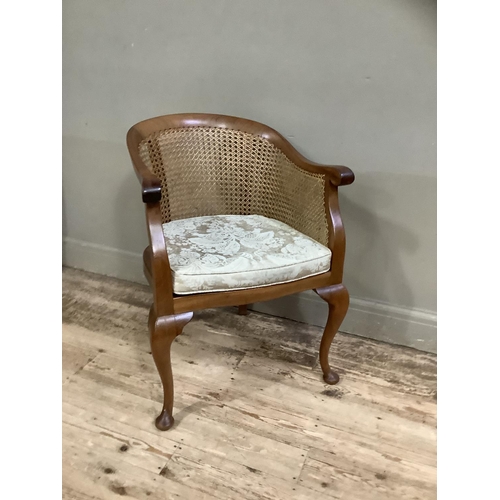 393 - A 1920s/30s walnut and begere tub backed chair on cabriole legs with upholstered cushion