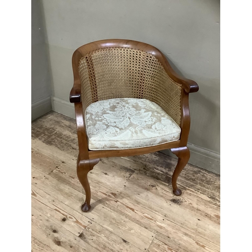 393 - A 1920s/30s walnut and begere tub backed chair on cabriole legs with upholstered cushion