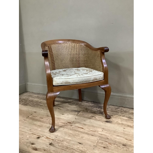 393 - A 1920s/30s walnut and begere tub backed chair on cabriole legs with upholstered cushion