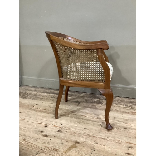 393 - A 1920s/30s walnut and begere tub backed chair on cabriole legs with upholstered cushion