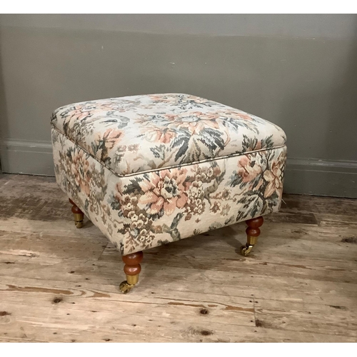 395 - An upholstered box foot stool on turned legs with brass caps and casters with Scotch Guard