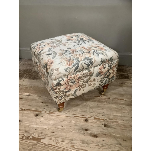 395 - An upholstered box foot stool on turned legs with brass caps and casters with Scotch Guard