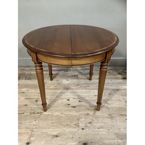 402 - A good modern cherry wood dining table of oval outline on turned legs, with extra leaf, 160cm with l... 