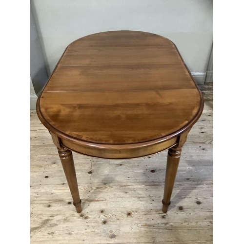 402 - A good modern cherry wood dining table of oval outline on turned legs, with extra leaf, 160cm with l... 