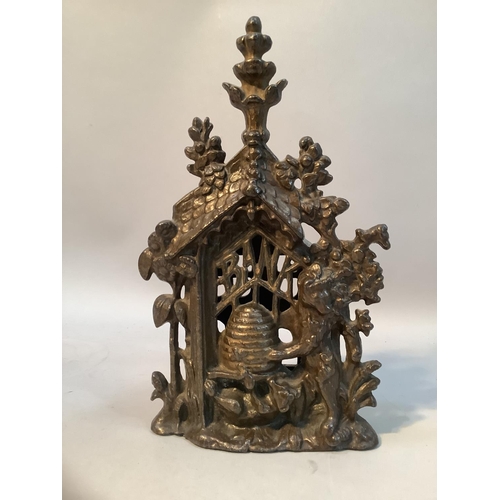 41 - A late Victorian cast iron money box modelled as a bear and bee hive