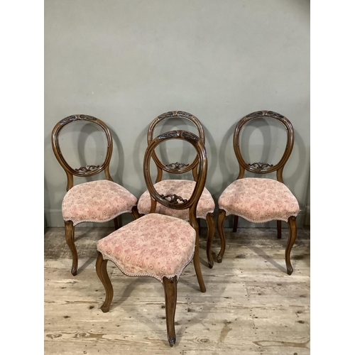 415 - A set of four Victorian mahogany balloon back chairs, foliate carved, upholstered serpentine seats a... 