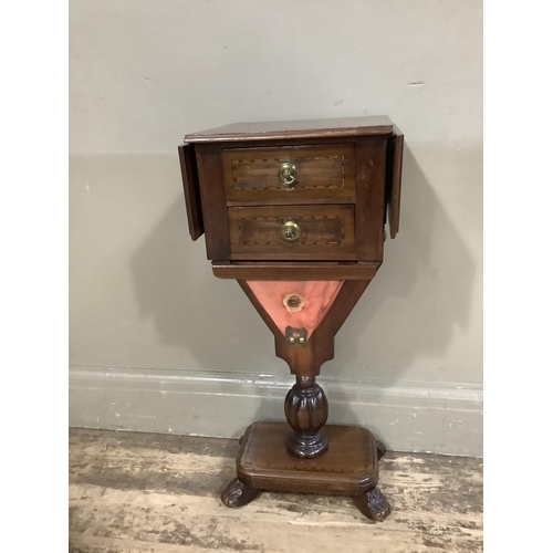 417 - A mahogany Pembroke work table with two drawers and well, pedestal base with platform and foliate fe... 