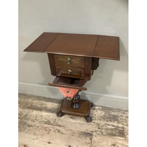 417 - A mahogany Pembroke work table with two drawers and well, pedestal base with platform and foliate fe... 