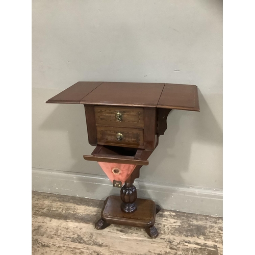 417 - A mahogany Pembroke work table with two drawers and well, pedestal base with platform and foliate fe... 