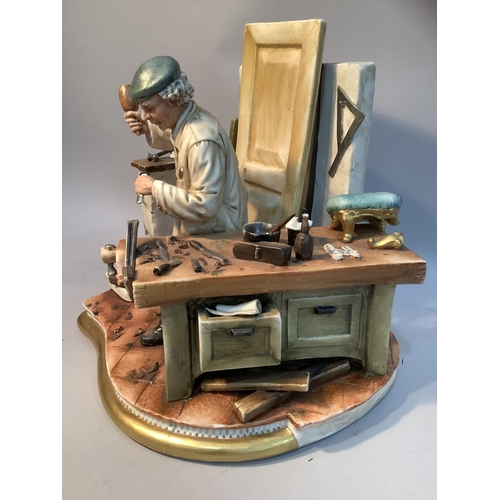 45 - A Capodimonte porcelain figure group of 'Farlegname' in his workshop, by Cazzola, 23cm high