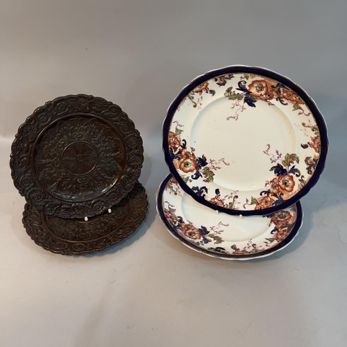 60 - A pair of 19th century brown drabware pottery plates, heavily moulded with acanthus leaves and swans... 