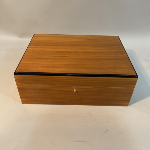 64 - A Hillwood walnut and ebonised laquered humidor, 30cm wide