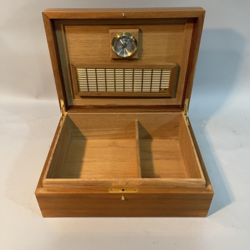 64 - A Hillwood walnut and ebonised laquered humidor, 30cm wide