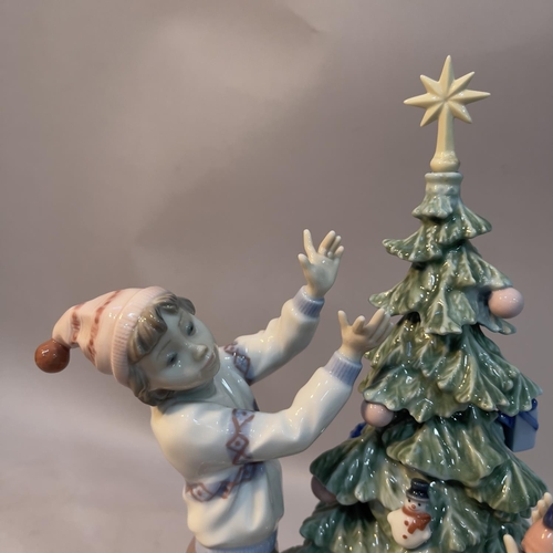 65 - A Lladro figure group 'Trimming the Tree' 34cm high