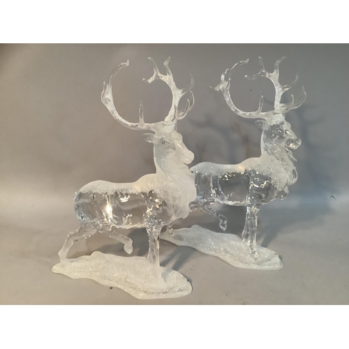 69 - A pair of clear resin models of stags with applied glitter, 28cm high