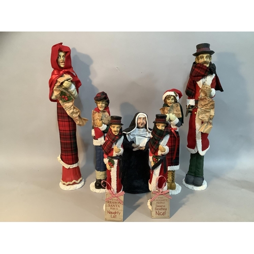 71 - Six resin figures of carol singers and a singing nun