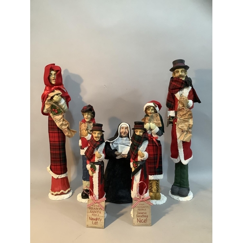 71 - Six resin figures of carol singers and a singing nun