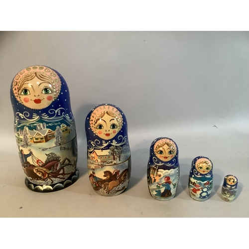 74 - A Russian Babushka doll painted with winter scenes having four dolls within
