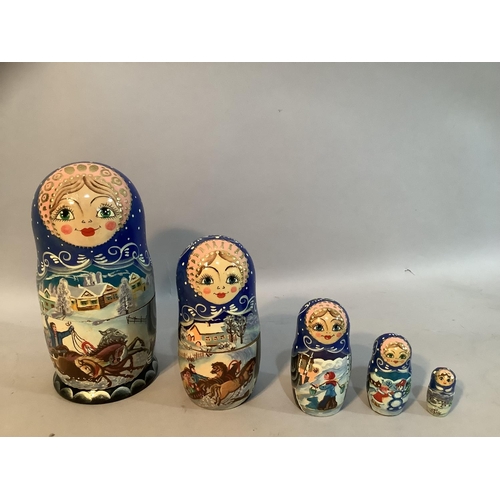 74 - A Russian Babushka doll painted with winter scenes having four dolls within