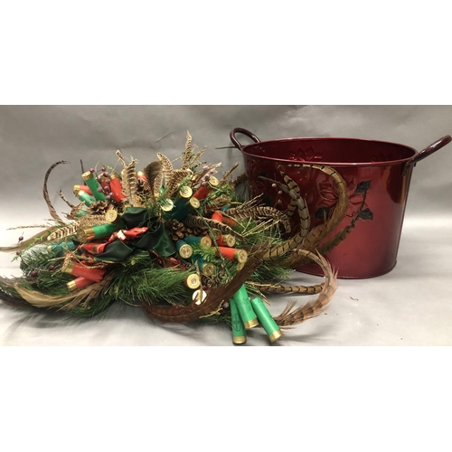 75 - Christmas table centrepiece formed of faux pine foliage, pheasant feathers and gun cartridges togeth... 