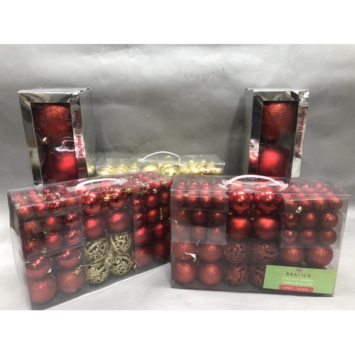 79 - A quantity of gold and red glittery baubles in five boxes
