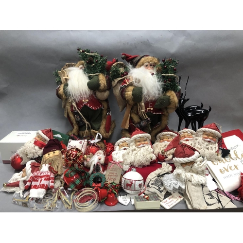 83 - Two figures of Santa as an explorer with skis, lamps and sacks together with Christmas tea towels, C... 