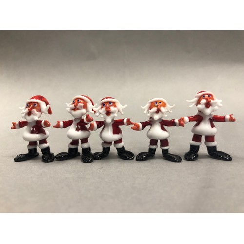 70 - Six Murano glass Santa figures with two skiing Santas with some damages