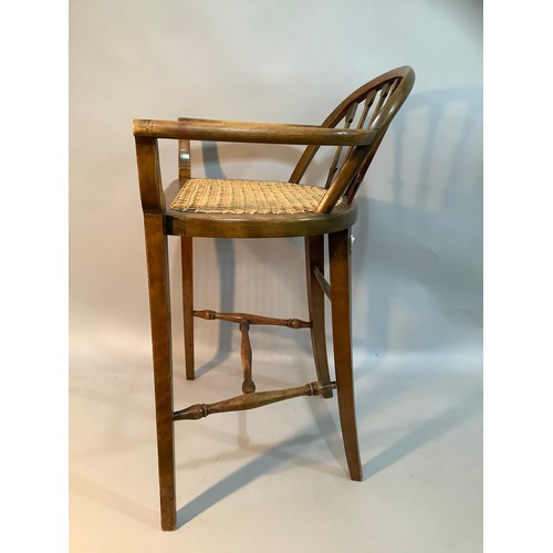 409 - A stained beech and begere caned low back chair on turned and square framing