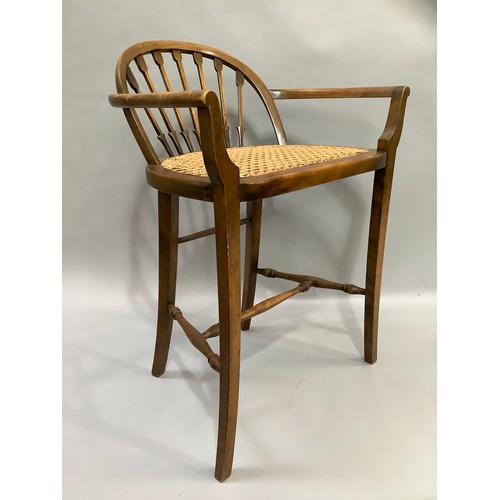 409 - A stained beech and begere caned low back chair on turned and square framing