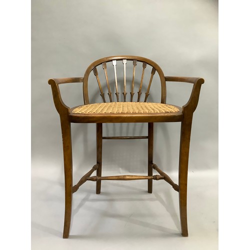 409 - A stained beech and begere caned low back chair on turned and square framing