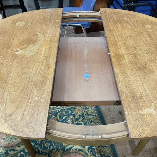 416 - A teak extending dining table by Nathaniel with cross banded surface, moulded apron and on tapered l... 