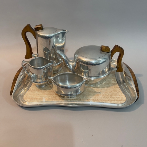 47 - A Piquotware aluminium tea set comprising teapot, milk jug, sugar bowl, hot water pot and serving tr... 