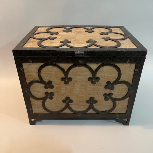 48 - An Arts and Crafts limed oak box, bound with wrought iron tracery, on pierced bracket feet, 38cm wid... 