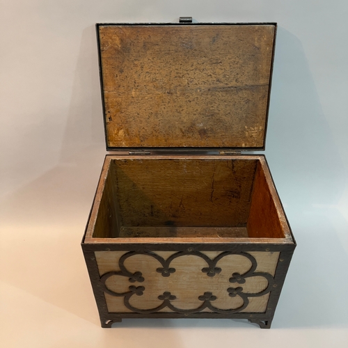 48 - An Arts and Crafts limed oak box, bound with wrought iron tracery, on pierced bracket feet, 38cm wid... 