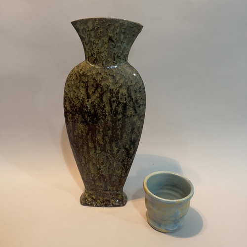 49 - A studio pottery vase of slender form with flared neck having a dripped brown and green glaze marked... 