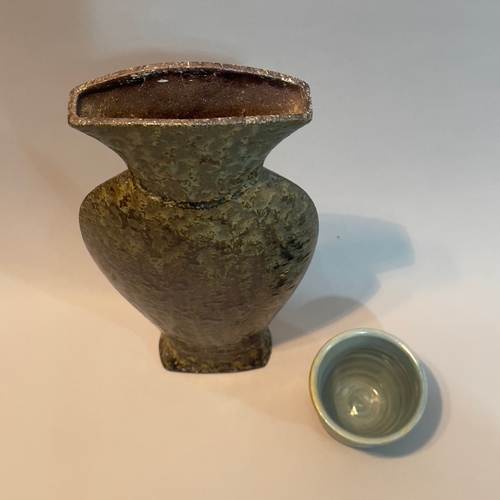 49 - A studio pottery vase of slender form with flared neck having a dripped brown and green glaze marked... 