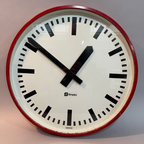 53 - A large red cased Simplex wall clock 55cm diameter