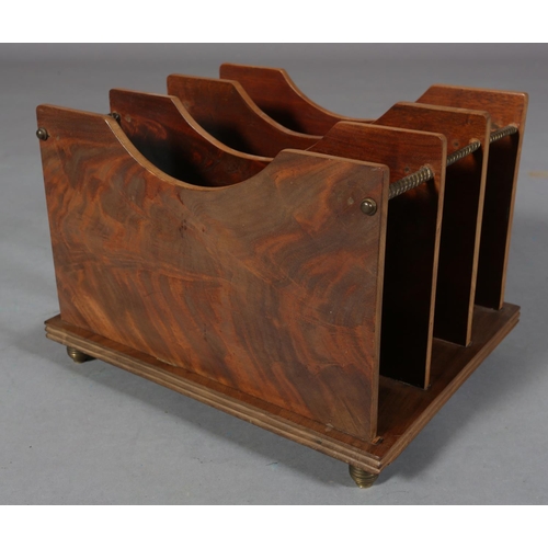 100 - An Art Deco figured mahogany magazine rack, of three panelled divisions with gilt metal rails and fe... 