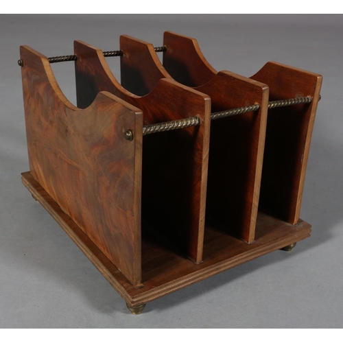 100 - An Art Deco figured mahogany magazine rack, of three panelled divisions with gilt metal rails and fe... 