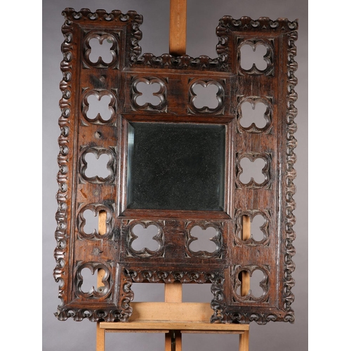 122 - Architectural salvage: a Victorian oak framed mirror held within an H-shaped Gothic tracery frame 10... 