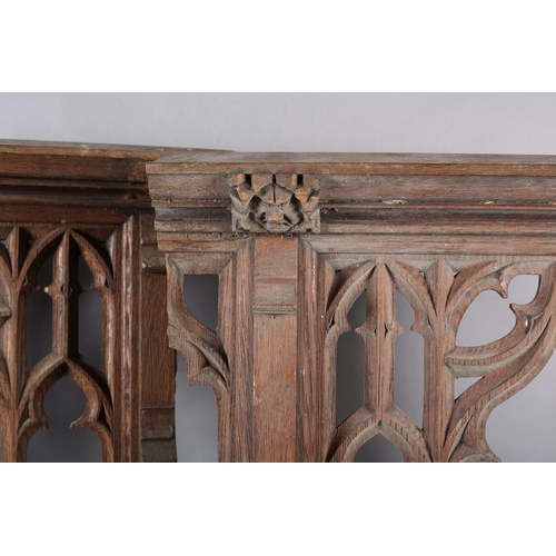 123 - Architectural Salvage: a pair of bleached oak front panels having a central arch with Gothic tracery... 