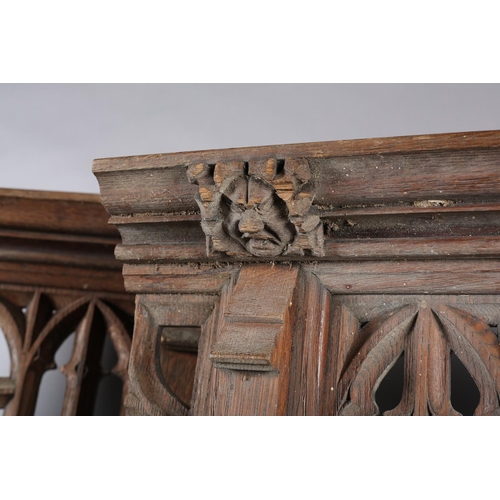 123 - Architectural Salvage: a pair of bleached oak front panels having a central arch with Gothic tracery... 