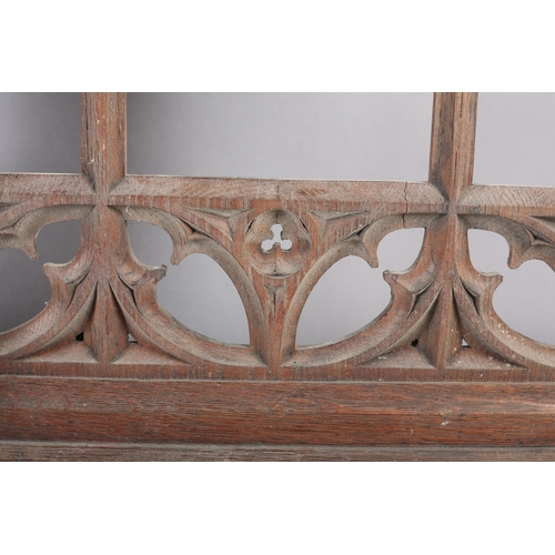 123 - Architectural Salvage: a pair of bleached oak front panels having a central arch with Gothic tracery... 