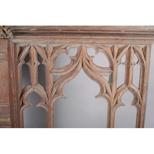 123 - Architectural Salvage: a pair of bleached oak front panels having a central arch with Gothic tracery... 